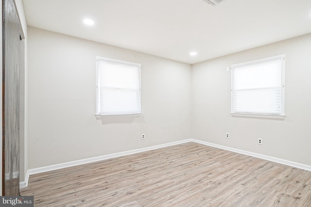 empty room with light hardwood / wood-style flooring