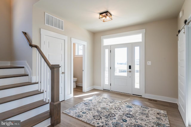 entryway featuring light hardwood / wood-style floors and a barn door