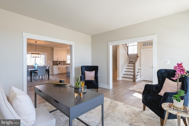 living room with a healthy amount of sunlight and light hardwood / wood-style flooring