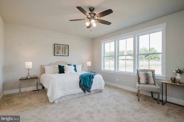 bedroom featuring light carpet and ceiling fan