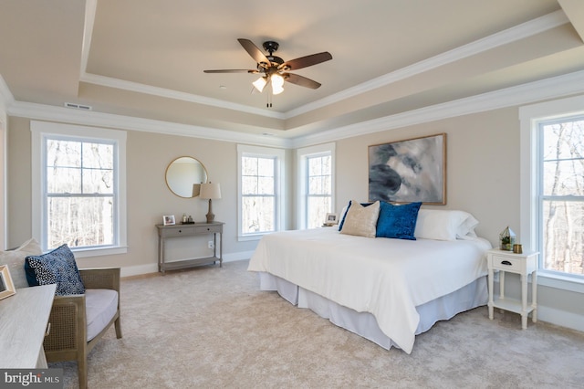 bedroom featuring multiple windows, crown molding, a raised ceiling, and carpet flooring