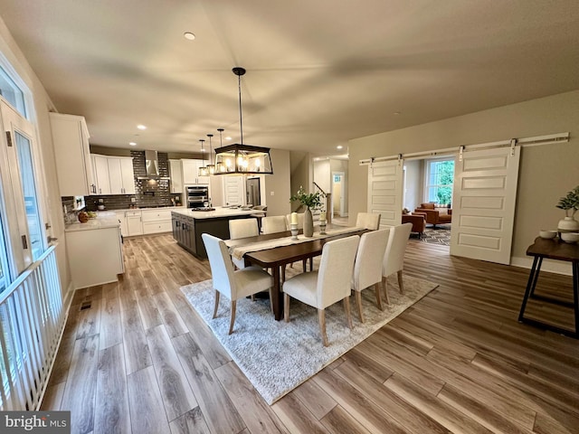 3104 Paper Mill Rd, Phoenix, MD 21131 - dining room with a barn door, recessed lighting, wood finished floors, and a chandelier