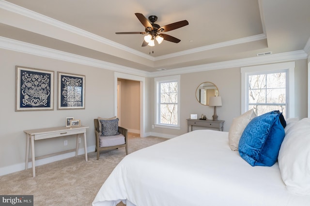 bedroom featuring light carpet, crown molding, a raised ceiling, and ceiling fan