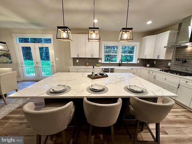 3104 Paper Mill Rd, Phoenix, MD 21131 - kitchen featuring gas cooktop, tasteful backsplash, white cabinets, a kitchen island, and recessed lighting