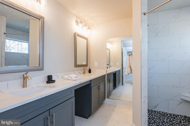 bathroom with vanity and a shower