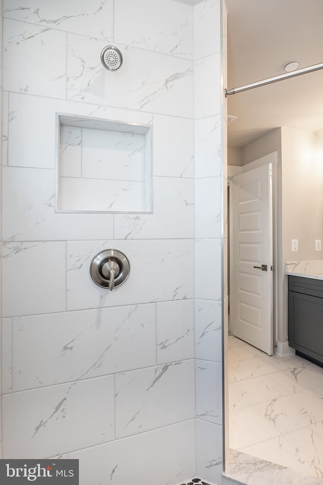 bathroom with vanity and a shower