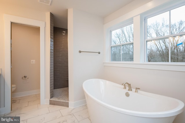 bathroom with toilet and separate shower and tub