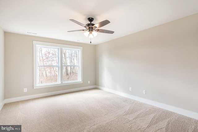 spare room with ceiling fan and carpet flooring