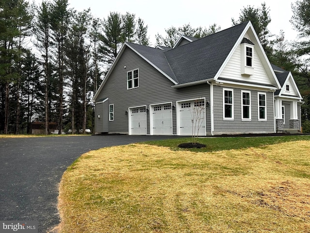 3104 Paper Mill Rd, Phoenix, MD 21131 - view of side of home featuring a garage, asphalt driveway, a shingled roof, and a yard