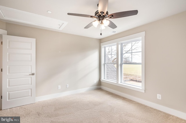 carpeted spare room with ceiling fan