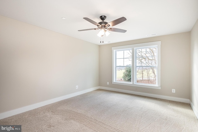 spare room with ceiling fan and carpet