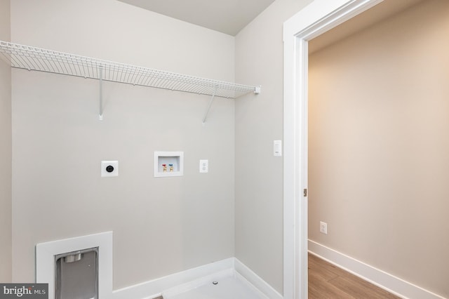 clothes washing area with hookup for a washing machine, wood-type flooring, and electric dryer hookup