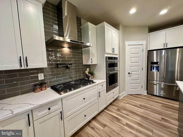 3104 Paper Mill Rd, Phoenix, MD 21131 - kitchen featuring stainless steel appliances, wall chimney range hood, white cabinets, decorative backsplash, and recessed lighting