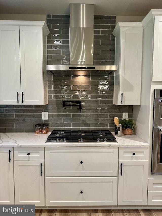 3104 Paper Mill Rd, Phoenix, MD 21131 - kitchen featuring wall chimney exhaust hood, tasteful backsplash, gas stovetop, and white cabinets