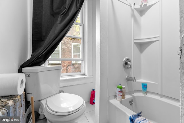 bathroom with toilet, tile patterned floors, shower / bathtub combination, and a healthy amount of sunlight