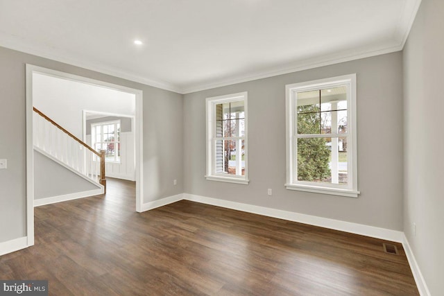 empty room with crown molding and dark wood-type flooring