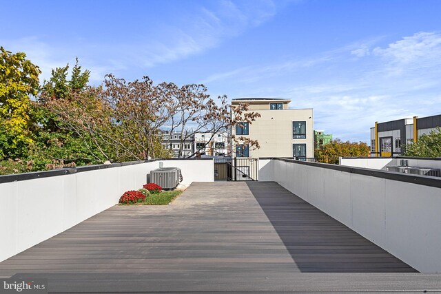 wooden deck featuring cooling unit