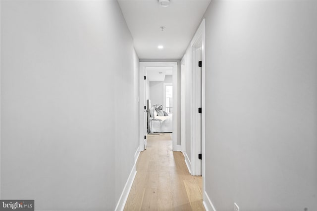 corridor with light wood-type flooring