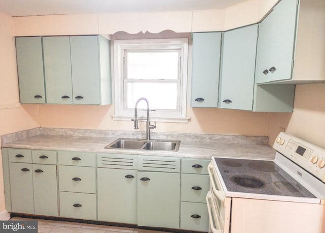 kitchen featuring white range with electric cooktop and sink