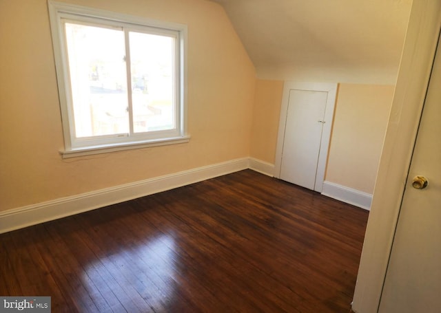 bonus room featuring dark hardwood / wood-style floors and vaulted ceiling