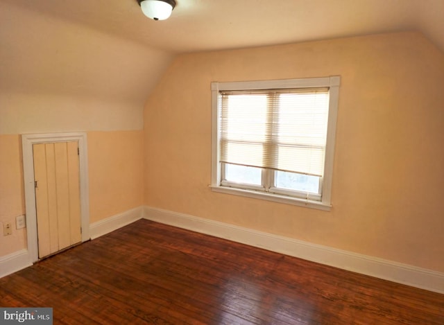 bonus room featuring dark hardwood / wood-style flooring and vaulted ceiling