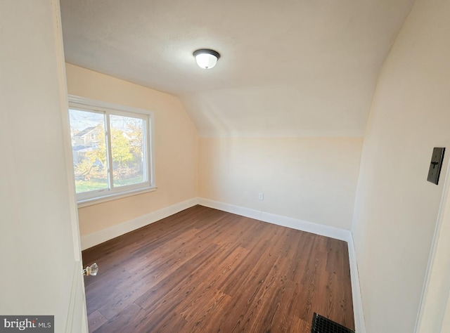 bonus room featuring dark hardwood / wood-style flooring and vaulted ceiling