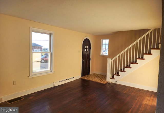 entrance foyer featuring a healthy amount of sunlight, wood-type flooring, and baseboard heating