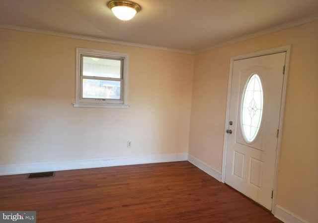 foyer with a wealth of natural light, crown molding, and dark hardwood / wood-style floors