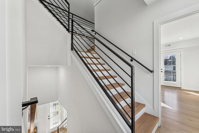 stairway featuring hardwood / wood-style flooring