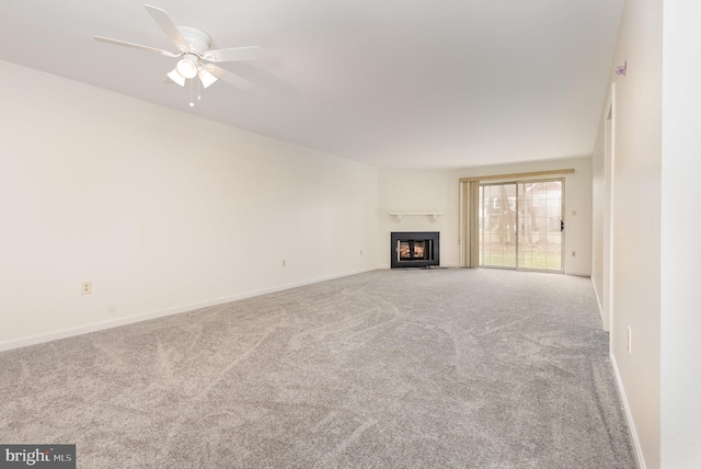 unfurnished living room featuring light carpet and ceiling fan