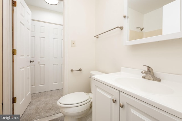 bathroom with walk in shower, vanity, and toilet