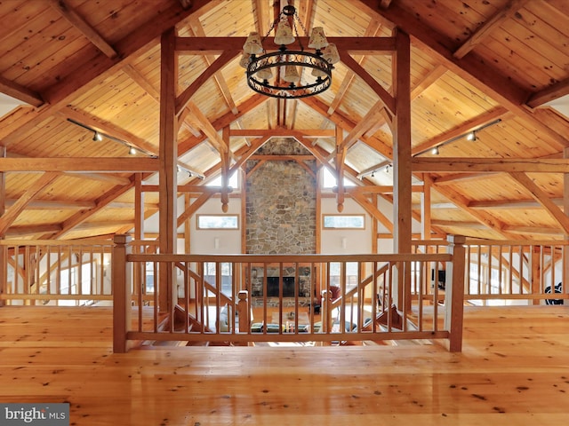 interior space with hardwood / wood-style flooring, wood ceiling, rail lighting, and lofted ceiling with beams