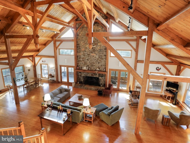 living room with wood ceiling, a fireplace, and french doors