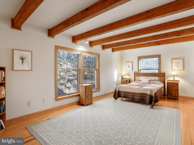 bedroom featuring wood-type flooring and beam ceiling