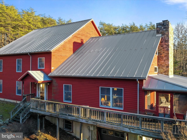 rear view of property featuring a wooden deck