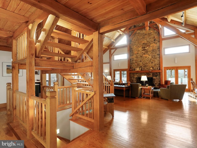 interior space featuring beamed ceiling, wood ceiling, wood-type flooring, and french doors