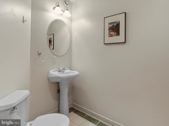 bathroom with tile patterned floors and toilet