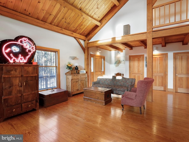 living area with wood ceiling, beamed ceiling, and light wood-type flooring