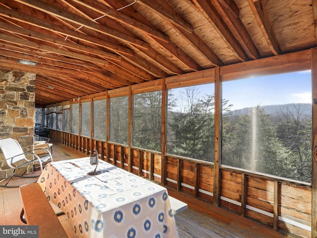 unfurnished sunroom with wood ceiling and vaulted ceiling