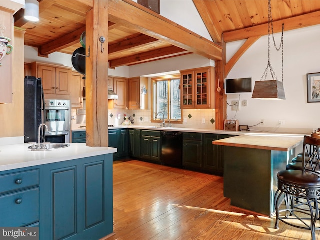 kitchen with sink, tasteful backsplash, hanging light fixtures, wooden ceiling, and black appliances