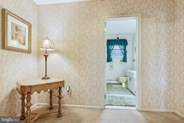 corridor featuring carpet flooring, a baseboard radiator, and ornamental molding