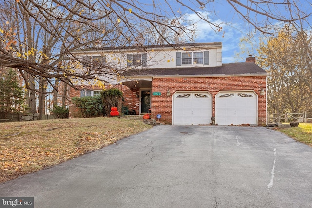 view of property with a front yard and a garage