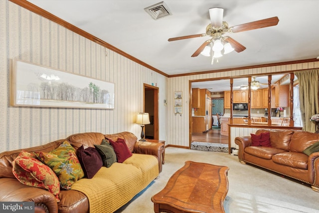 living room featuring ceiling fan, light colored carpet, and ornamental molding