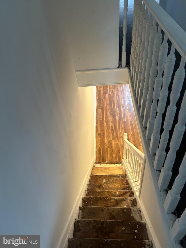 stairs featuring wood-type flooring