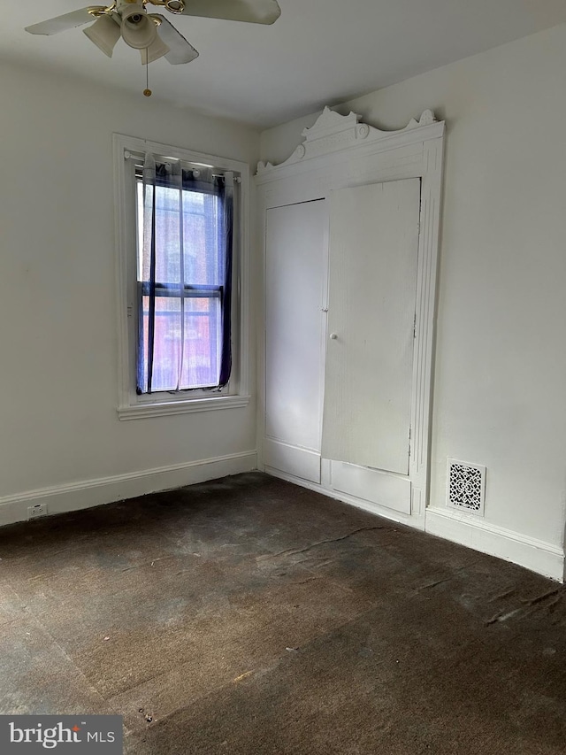 carpeted empty room with ceiling fan