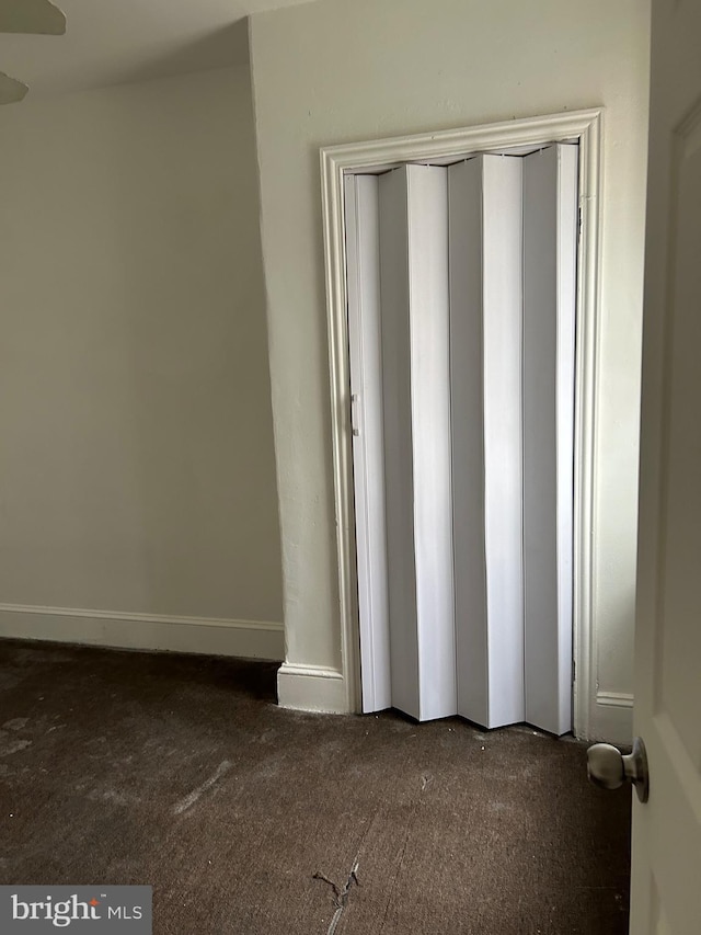 unfurnished bedroom featuring dark colored carpet