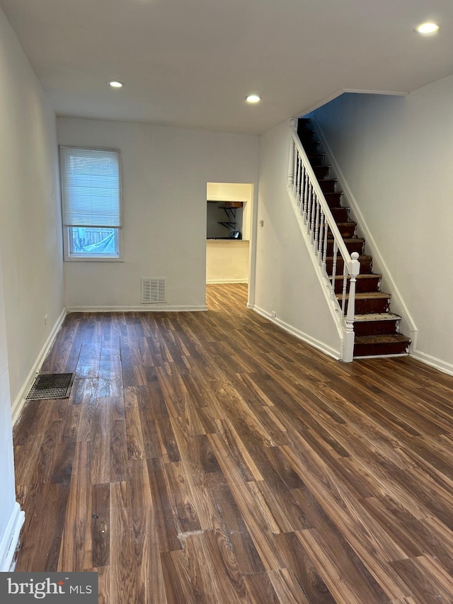 unfurnished living room with dark hardwood / wood-style floors