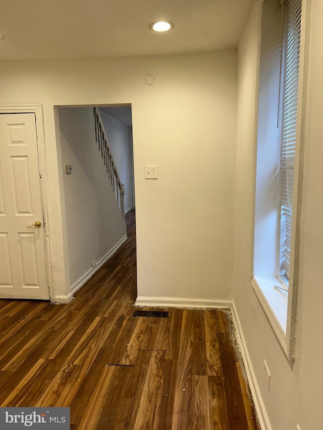 hall with dark wood-type flooring