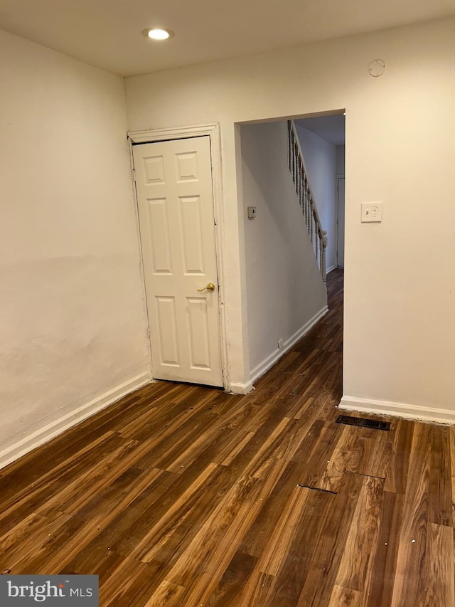 empty room featuring dark wood-type flooring