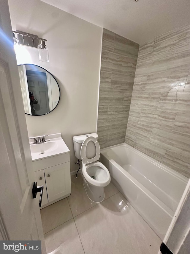 full bathroom featuring tile patterned flooring, vanity, tiled shower / bath combo, and toilet